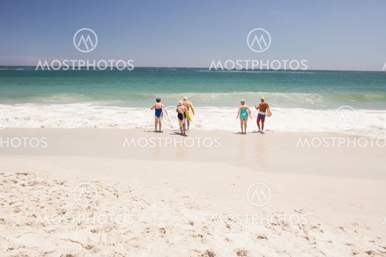 Senior friends holding surfboard