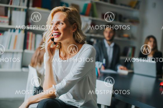 Businesswoman using mobile phone in office