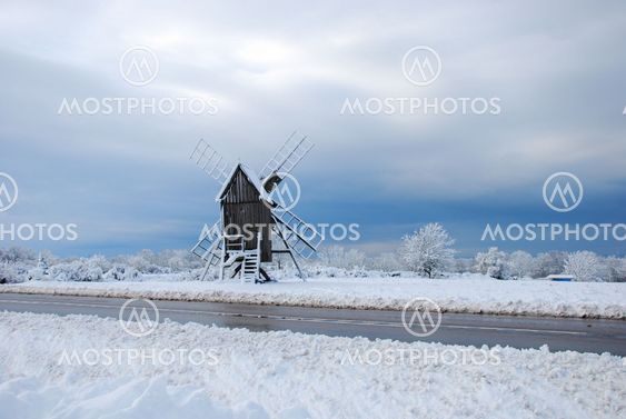 Old wooden windmill by roadside