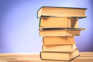 Vintage old books on wooden deck table