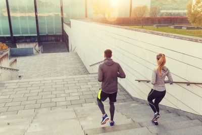 couple running downstairs on city stairs