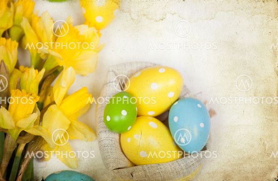 Easter backgound off painted eggs and yellow flowers