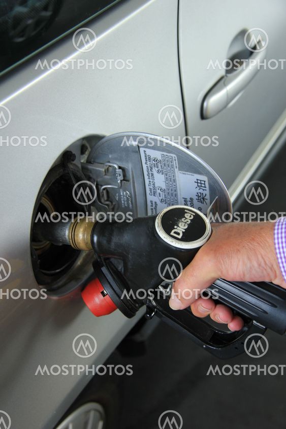 Pumping gas at a gas station