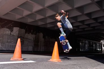 City, jump and man with skateboard, contest and skills...