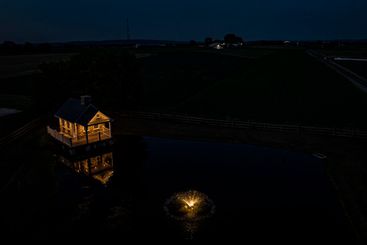 Dusk On Farm With Stone House, Pond, And Fountain