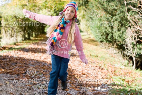 Young girl playing in woods