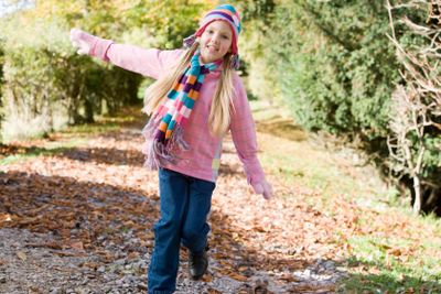Young girl playing in woods