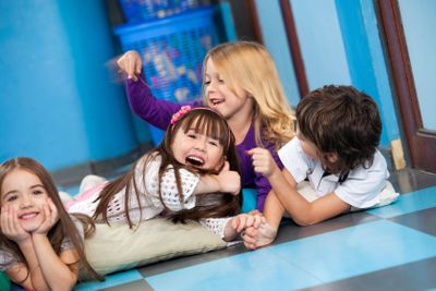 Playful Children Lying On Floor