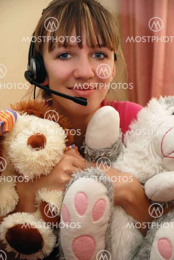 Cute young woman huging toys
