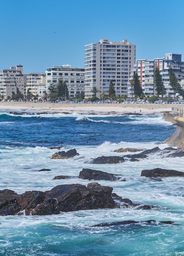 City, nature and waves on beach for vacation, holiday...