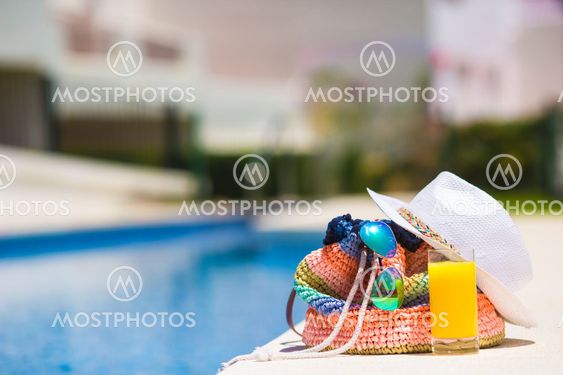Summer concept-straw bag, tasty orange juice and white...