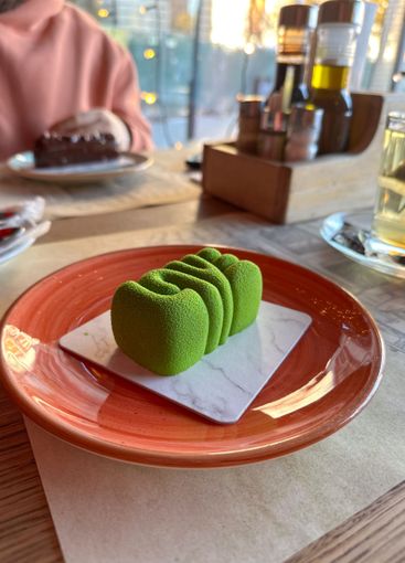 Close-up view of the same green LOVE dessert in a cafe...