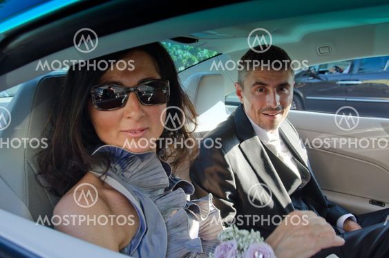 Bride and Groom in the Car after Wedding