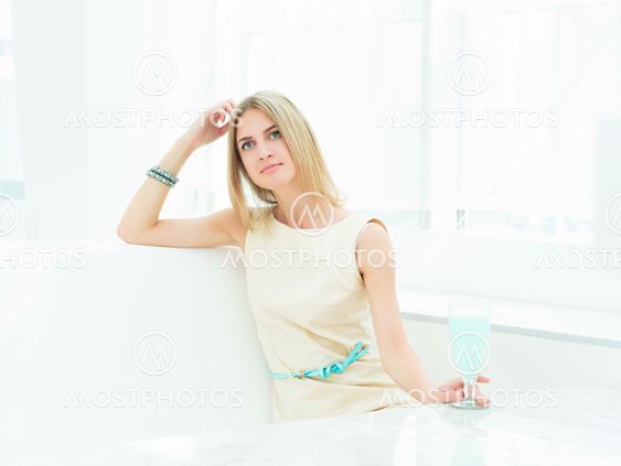 Portrait of a cute woman in a city cafe