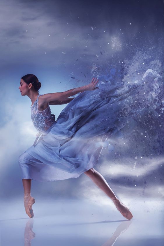 The beautiful ballerina dancing in blue long dress