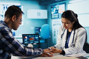 Healthcare professional uses oximeter to measure oxygen...