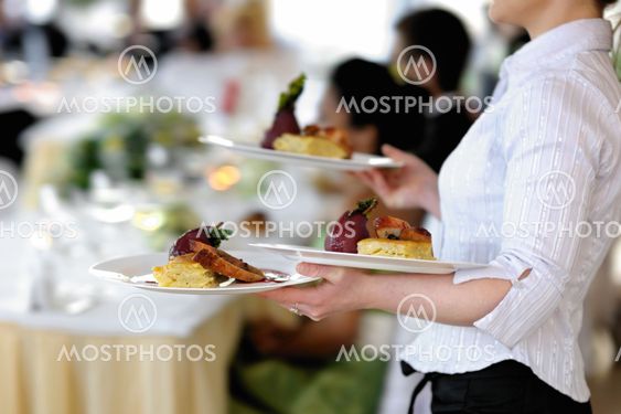 Waitress is carrying three plates
