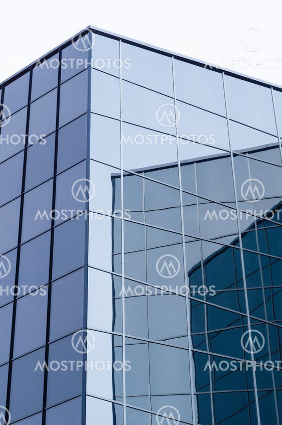 Modern glass and steel building with wall reflections
