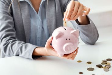 Economy during quarantine. Business woman with piggy bank