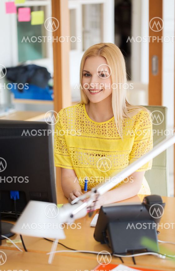 businesswoman with computer and phone at office