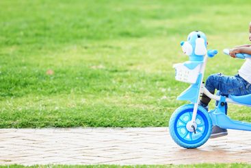 African boy, bike and park for learning, childhood and...