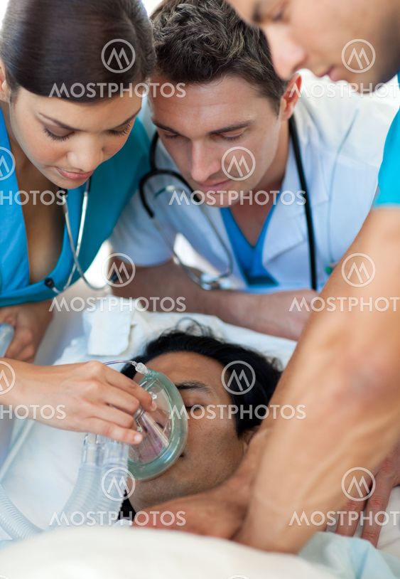 Doctor putting oxygen mask on a patient