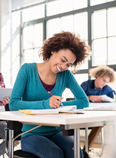 Student concentrating while writing an essay during class...