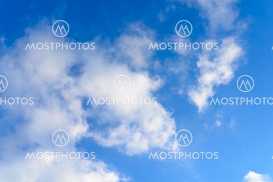 Bright blue sky & puffy clouds as background