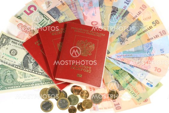 Many banknotes and passports.Many banknotes of different countries and the passport for travel.