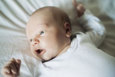 Baby closeup, newborn and young chile face in a nursery...