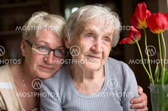 Woman sitting with her elderly mother.