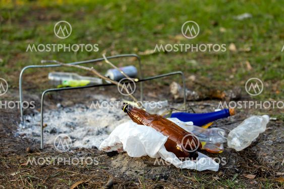 A pile of garbage in the forest park near the campfire...