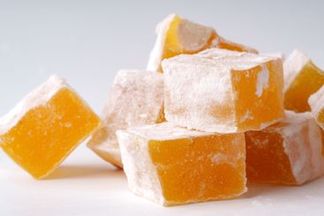 Delightful yellow Turkish delight cubes stacked artfully...