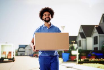 Smiling courier delivering a package in a postal service...