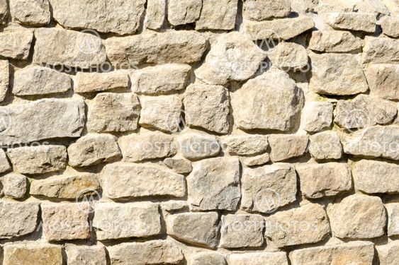Texture of a wall made of crushed rocks