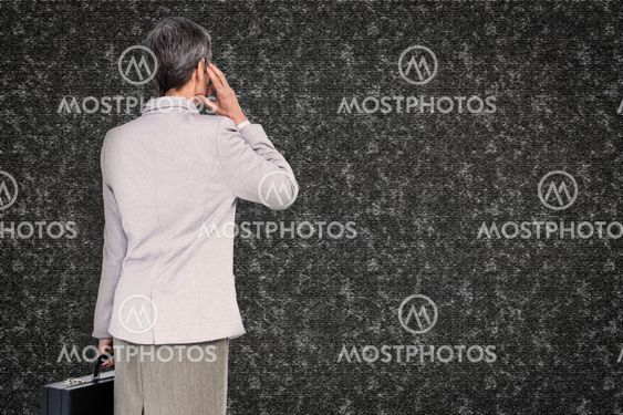Composite image of businesswoman on the phone