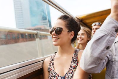 teenage girl with friends traveling by tour bus
