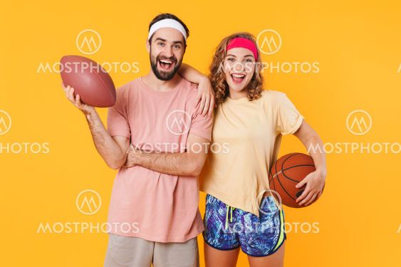 Portrait of young happy caucasian fitness couple holding...