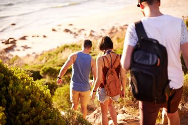 Walking, travel and back of people by beach for journey,...