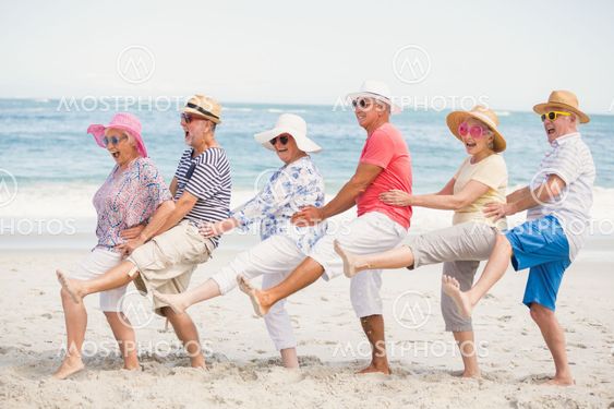 Senior friends dancing on the beach