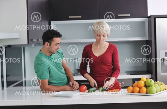 young couple have fun in modern kitchen