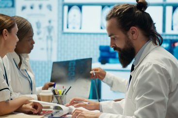 Medical professionals analyzing anatomy x ray scans to...