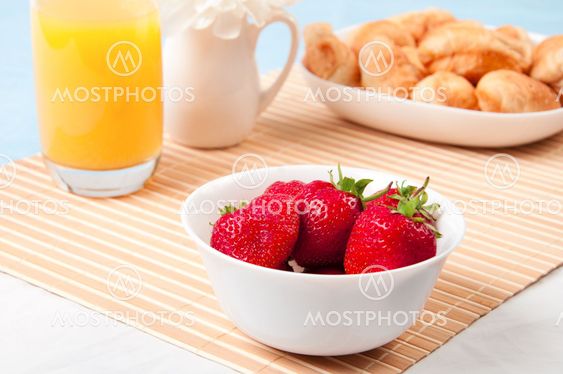 Breakfast with berries,orange juice and croissant