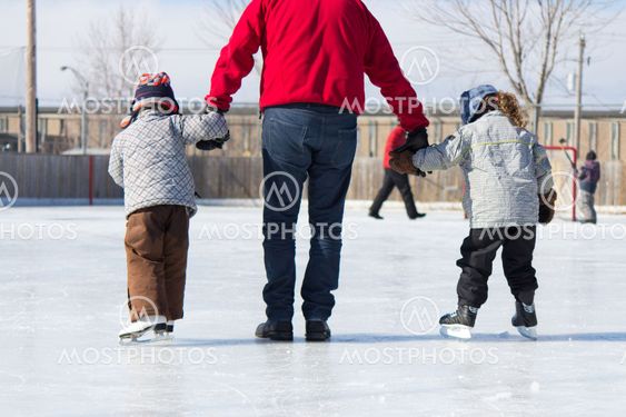 Family having fun at the skating rink