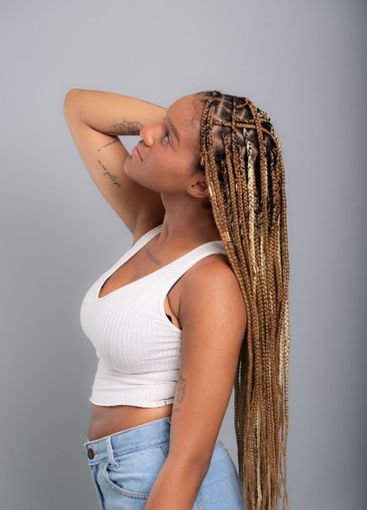 Portrait of beautiful brunette woman with braids in her...