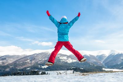 Young woman jumping in the mountains