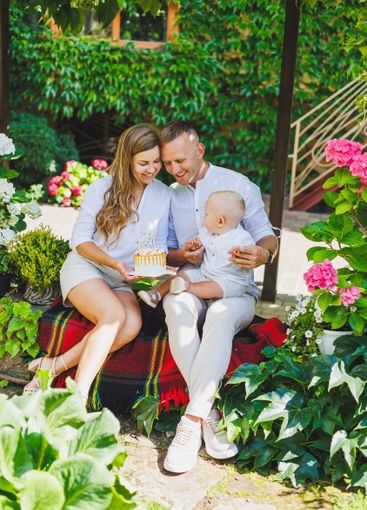 Mom and dad in nature with their one-year-old son...