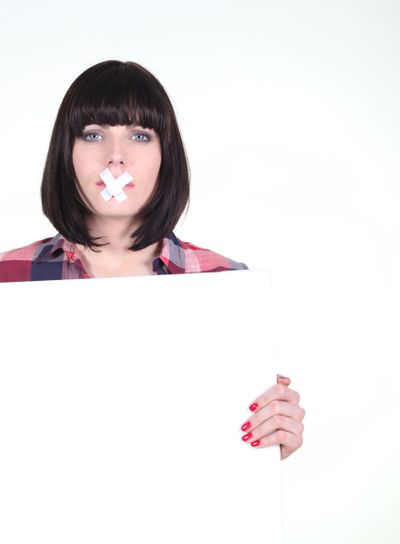 Woman with white panel and bandage on the mouth