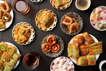 Delightful array of traditional sweets served on ornate...