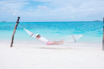 A young man in shorts and a T-shirt is lying in a...